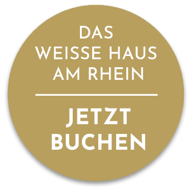 Goldener Kreis mit weißer Schrift: Das Weisse Haus am Rhein. Jetzt buchen.